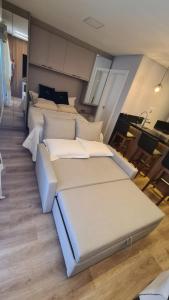 a room with four beds and a table in it at Studio Pomerode in Pomerode