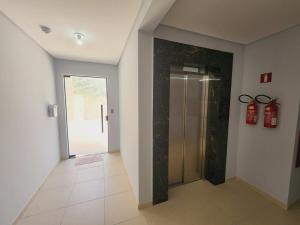 a hallway with a walk in shower and a glass door at Studio Pomerode in Pomerode