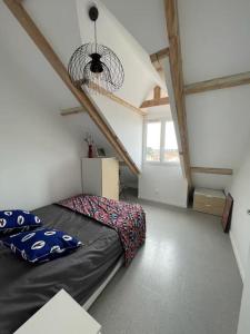 a bedroom with a bed in a room at Barneville Plage in Barneville-Carteret