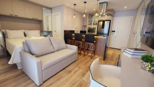a living room and kitchen with a bed and a couch at Studio Pomerode in Pomerode