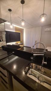a kitchen with a sink and a counter top at Studio Pomerode in Pomerode