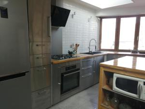 a kitchen with stainless steel appliances and a microwave at Maison sculptée in Vernon