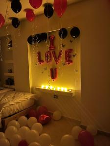 a room with balloons and a sign that reads love at Rafif hotel in Cairo