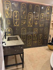 a room with a wall with hieroglyphics on it at Rafif hotel in Cairo