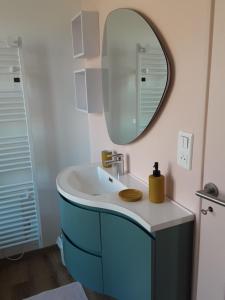 a bathroom with a sink and a mirror at Chez Simone - Charming cottage - Ideal for 6 people in Saint-Valery-sur-Somme