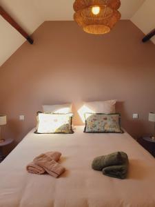 a bedroom with a bed with two towels on it at Chez Simone - Charming cottage - Ideal for 6 people in Saint-Valery-sur-Somme +6 photos