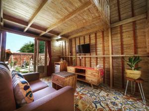 a living room with a couch and a tv in a room at Wisnu Lumbung Uluwatu in Uluwatu