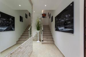 a staircase in a house with pictures on the walls at Residence Perla in Rimini