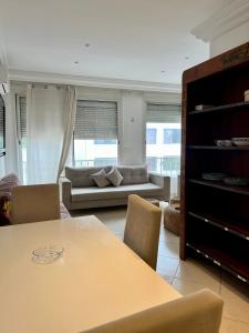 a living room with a table and a couch at Maison azur in Tunis