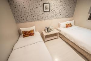 Postel nebo postele na pokoji v ubytování Golden Stone Hotel