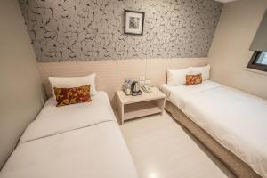 Postel nebo postele na pokoji v ubytování Golden Stone Hotel