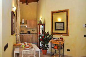 a kitchen with a mirror and a table with flowers at B&B Agrifoglio in SantʼElpidio a Mare