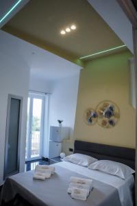 a bedroom with two beds with towels on them at Francy's bed & bliss in Somma Vesuviana