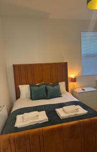 a bedroom with a large bed with two towels on it at Town centre apartments in Middlesbrough
