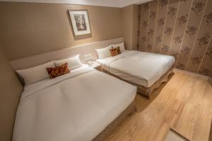 Postel nebo postele na pokoji v ubytování Golden Stone Hotel