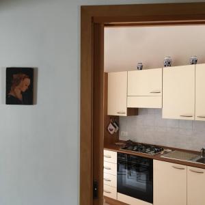 a kitchen with white cabinets and a stove top oven at Casa di Nonno Tilio in Priola