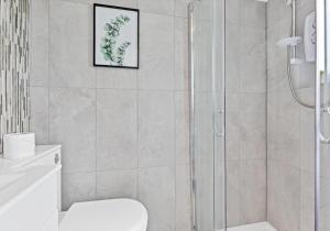 a bathroom with a shower and a toilet at On the Water 3 with Free Parking By My Getaways in Brighton & Hove