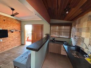 a kitchen with a sink and a counter top at Flat Bonito Jarinu 02 Centro in Bonito