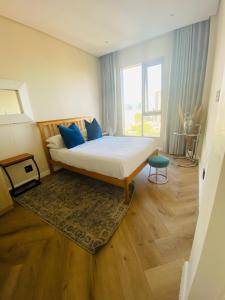 a bedroom with a bed and a large window at Cosy Uptown 2 Bedroom Sandton in Johannesburg