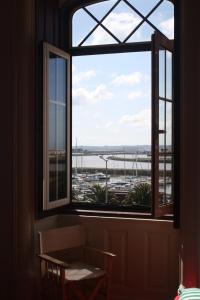 a window with a view of a harbor at Hostel 402 in Figueira da Foz