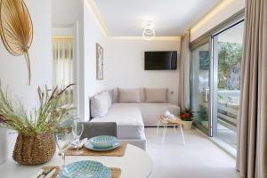 a living room with a couch and a table at Villa Marion in Chrysi Ammoudia
