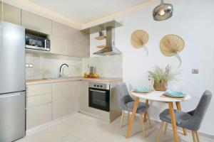a kitchen with a table and chairs and a refrigerator at Villa Marion in Chrysi Ammoudia