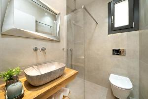 a bathroom with a sink and a toilet at Villa Marion in Chrysi Ammoudia +23 photos
