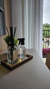 a tray with a bottle of perfume on a table at Studio Pomerode in Pomerode