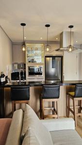 a kitchen with a couch and a counter top at Studio Pomerode in Pomerode
