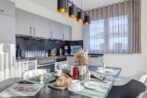 a kitchen with a table with a bread on it at Apartment B10 "Südbalkon mit Haffblick" im Pine Hill Resort in Zirchow