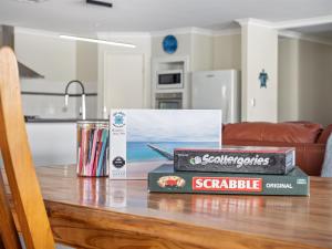 two stacks of books on a table in a kitchen at Busselton Broadwater Holiday Home in Busselton