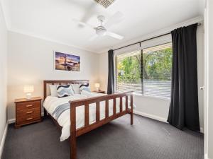 a bedroom with a bed and a window at Busselton Broadwater Holiday Home in Busselton