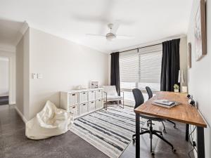 a dining room with a table and chairs and a desk at Busselton Broadwater Holiday Home in Busselton