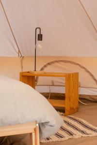 a bed and a table in a tent at Nomad Pop-Up Hotel Aljezur in Aljezur