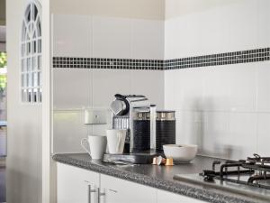 a kitchen counter with a coffee maker on it at Busselton Broadwater Holiday Home in Busselton