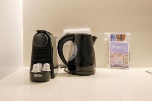 a black coffee maker sitting on top of a counter at GuestReady - Port Studio 4 in Bandeira