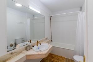 a bathroom with two sinks and a large mirror at Sunset Flower Apt By Dream Homes Tenerife in Puerto de Santiago +26 photos