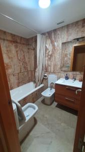a bathroom with a sink and a toilet and a tub at Marina d'Or Edificio Fase X - 1ª linea apartment in El Borseral
