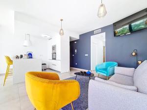 a living room with a couch and yellow chairs at Antilia Terraces Colibri Apartment - 5710 in Mar de Cristal
