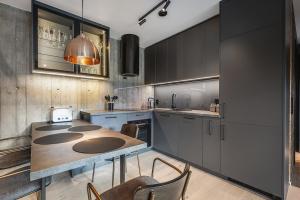 a kitchen with a table and some chairs in it at Apartment in Hemsedal in Hemsedal +8 photos