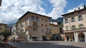 a street in a town with buildings and a statue at 1Dest - GardArco in Arco