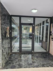 a glass door in a building with a tile floor at TRISAP Luxury Suites T Suite in Thessaloniki