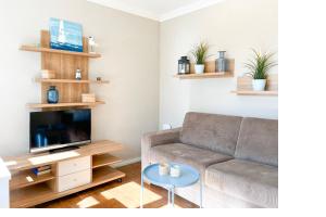 Μια τηλεόραση ή/και κέντρο ψυχαγωγίας στο Ferienhaus am Deich Wohnung 02