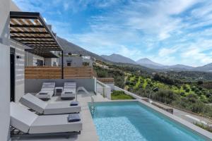 a villa with a swimming pool and a patio at Villa April, Seaview and pool in Marioú