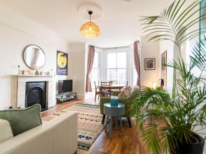 a living room with a couch and a fireplace at Snug Sea View 2 Bed Apartment - Margate Pass the Keys in Margate