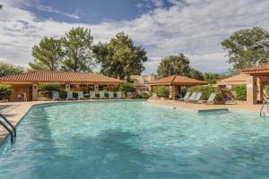 a large swimming pool with blue water at Quiet Serenity Retreat in Tucson