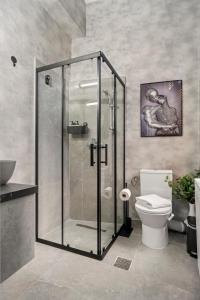 a bathroom with a shower and a toilet at Central Luxury Apartments with Private Garden & Parking in Bucharest +16 photos