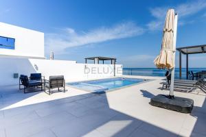 The swimming pool at or close to Sea Views 4BR and Assistant's Room Villa with Heated Pool, Sharm - Al Dana Villa, Al Dana Island by Deluxe Holiday Homes