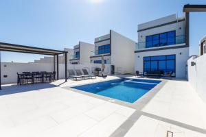 The swimming pool at or close to Sea Views 4BR and Assistant's Room Villa with Heated Pool, Sharm - Al Dana Villa, Al Dana Island by Deluxe Holiday Homes