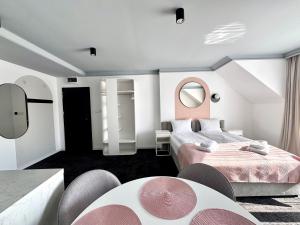 a hotel room with two beds and a mirror at BAJKOVA 6 in Busko-Zdrój